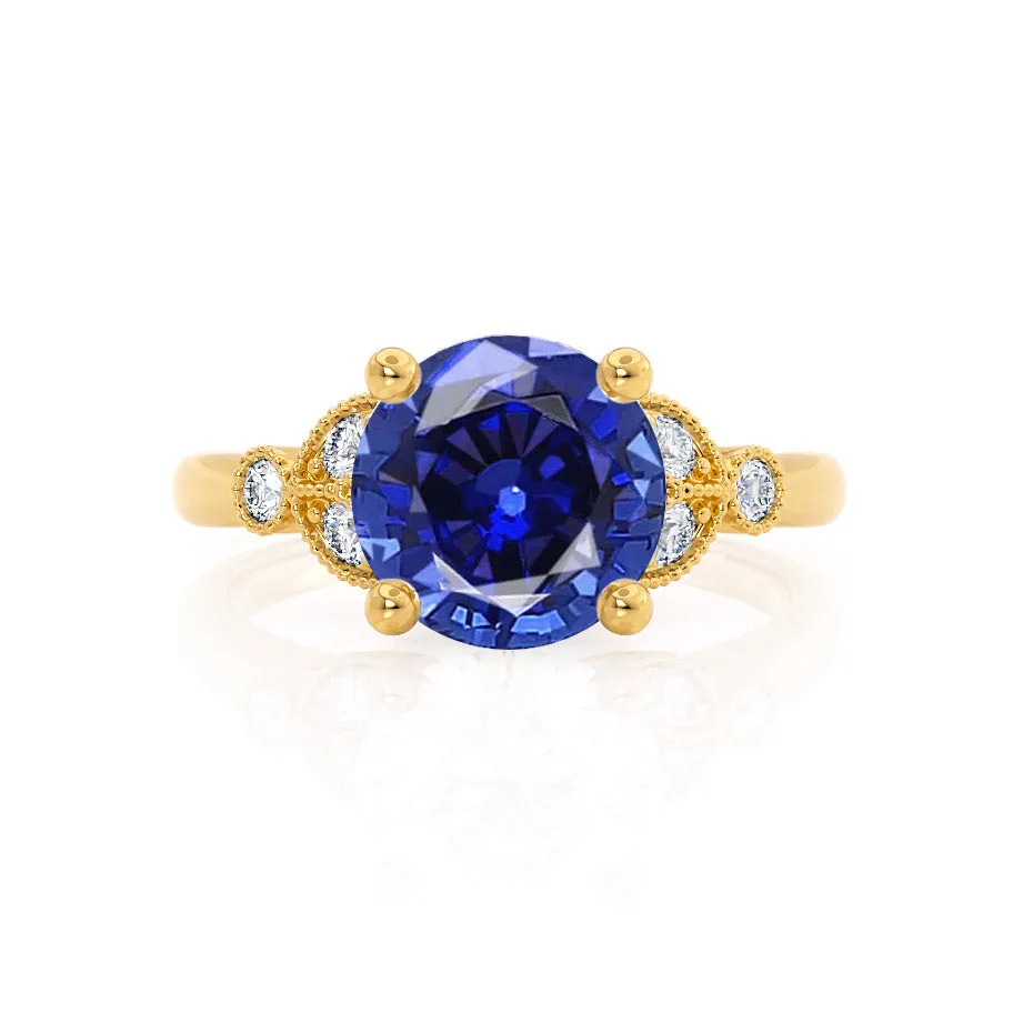 DELILAH - Chatham® Round Blue Sapphire 18k Yellow Gold Shoulder Set Ring